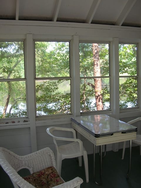 Relax on the screened porch overlooking the pond. Plenty of room to enjoy meals.
