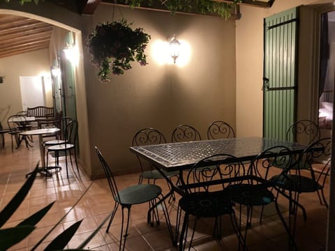 The pergola terrace & the long terrace at night looking towards the back garden