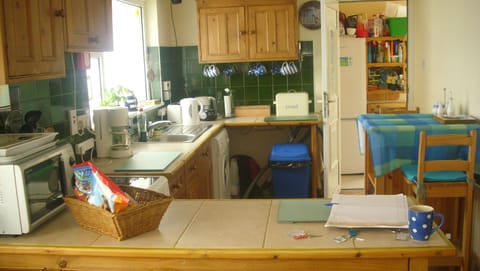 Kitchen, with storage and fridge/freezer at back.