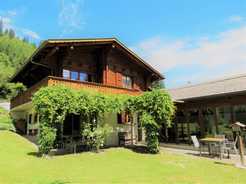 Chalet La Taupiniere from the garden, showing the pool room and terrace.