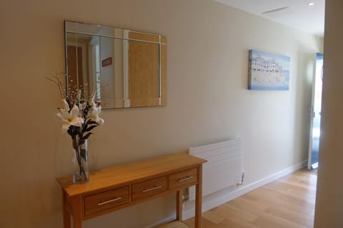 Hall with utility cupboard housing washer dryer