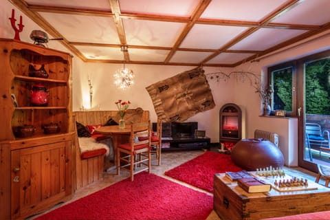 Living room. Single sofa bed and dining area leading onto the riverside balcony.