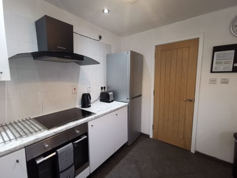 Photo of the kitchen taken from a different angle. Door to separate dining room.