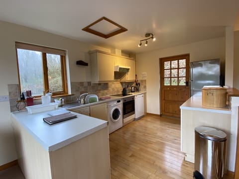 Modern well equipped kitchen with dishwasher, washing machine, oven & fridge frz