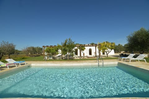 A heated pool, sun loungers