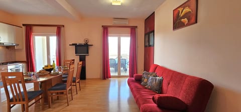 Open plan living/dining/kitchen area opening into sea view terrace