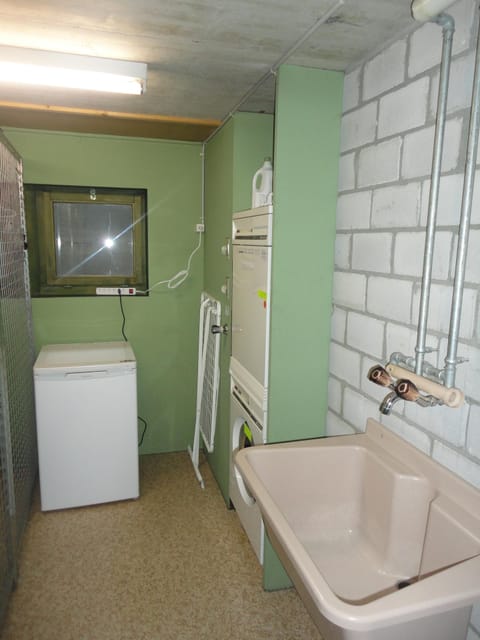 Private utility room with washing machine and tumble dryer