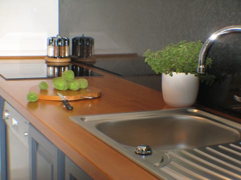 Kitchen with French Doors opening out to the garden with Weber Charcoal Barbeque