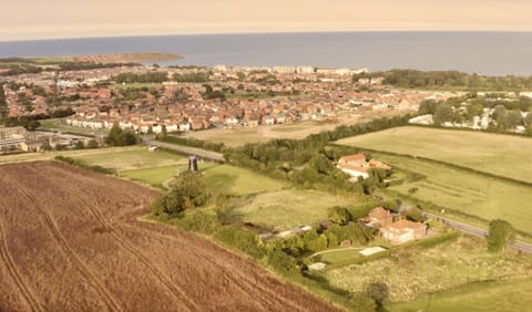 Mill Farm is the white buildings to the right of the black windmill