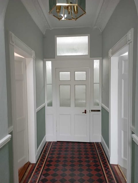 Ground floor entrance hall with original tiled floor.