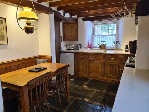 Table seating for 4, under counter fridge with small freezer compartment.