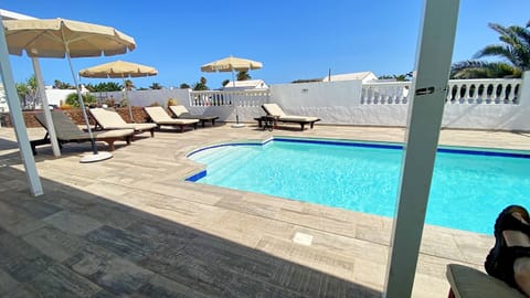 Outdoor pool, a heated pool, sun loungers