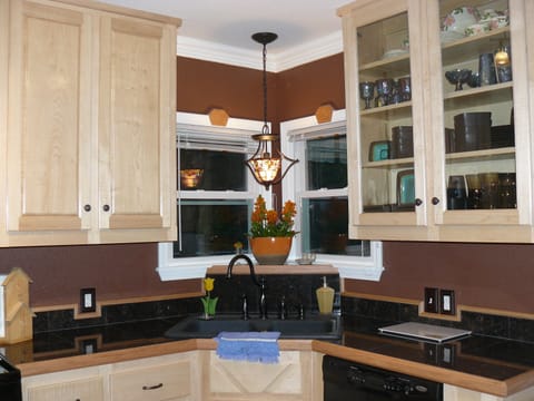 A corner sink and dishwasher. Full set of dishes & glasses for 6 provided.