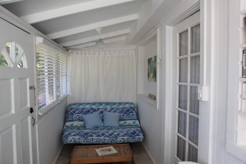 Porch room with sofa bed. Right door into living area.  Left to outside front 