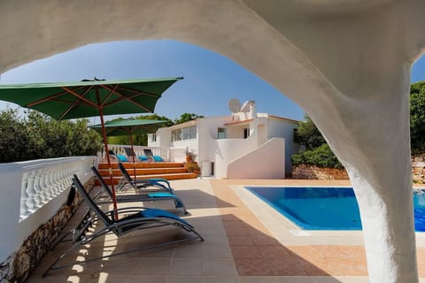 A heated pool, sun loungers