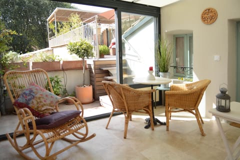 Sun room leads on to small terrace with steps up to large terrace