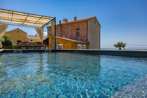 A heated pool, sun loungers