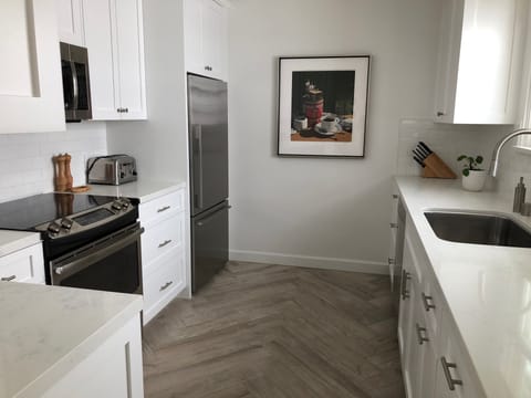 A full kitchen with stainless steel pots and pans for the serious cook.