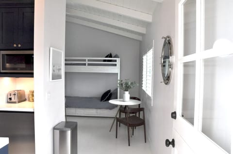 The entrance of the upstairs unit. A cute dutch door for a nice, cool breeze.