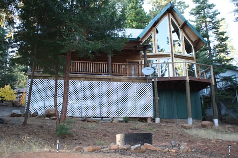 Front of cabin facing lake and mountain view with open and covered deck