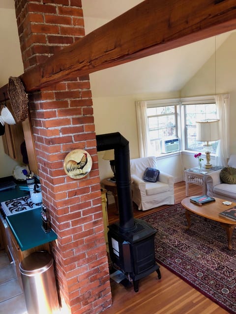 Brick work and open wood beam between living room and kitchen/dining area.