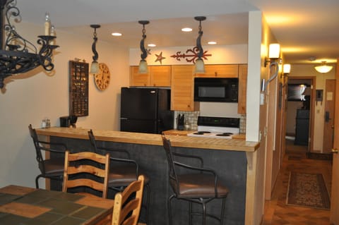 Bar and Kitchen. Hallway to bedroom, bathroom, entry on the right. W/D in hall