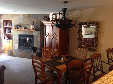 Gas fireplace and Dining area. Flat screen TV inside entertainment unit.