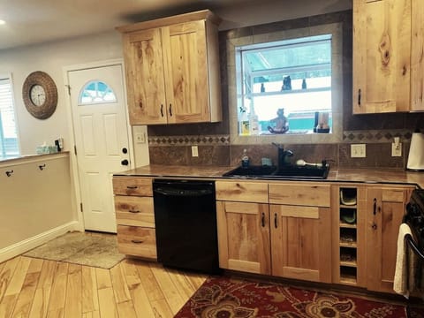 Kitchen and front door and dishwasher, sink and bay window