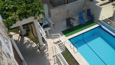 Birds eye on pool and lower level from upper level balcony