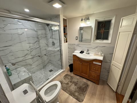 Bathroom with walk-in shower and bench.