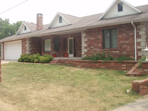 Front of house with double car garage. House is much larger than it appears.