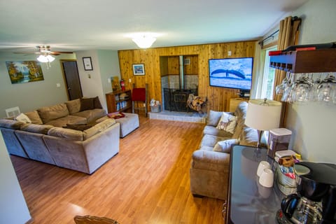 Living Room: Large sectional couches, wood fireplace, flatscreen TV with Netflix