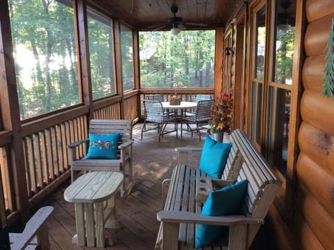 Screened in porch with plenty of seating and ceiling fans