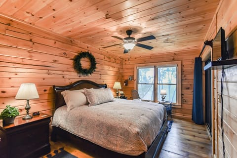 King bedroom with TV, ceiling fan, walk in closet and full bath