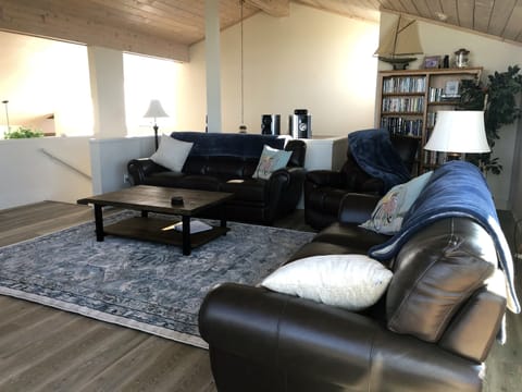 Living Room area looking down towards first floor. Vaulted ceilings and numerous sky lights give lots of natural lighting.