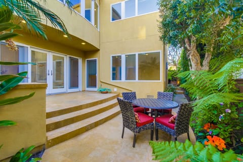 Tropical landscaping surrounds private side yard dining