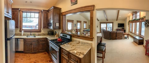 Full kitchen and bath adjoining family play room above garage