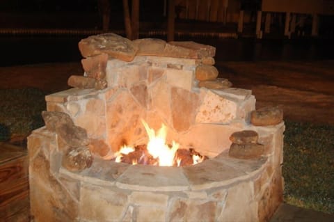 warm up by the outdoor fireplace in the cooler months
