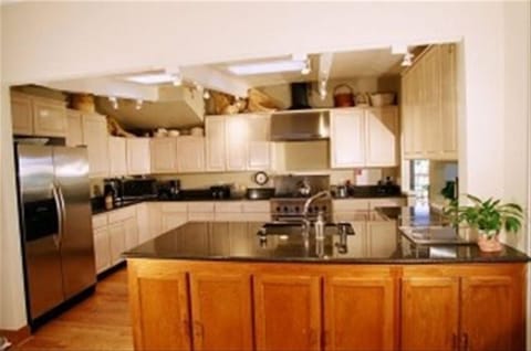 open,airy kitchen with gas stove,double door fridge microwave, and fully stocke