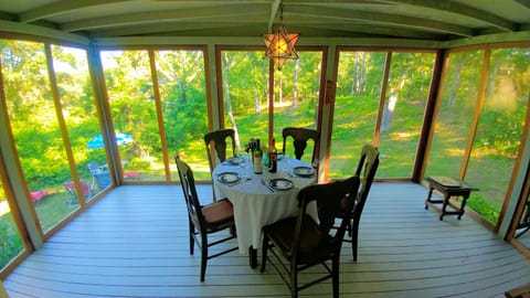 Dine in the fabulous screened in porch. With dining table for 4 & chaise lounger