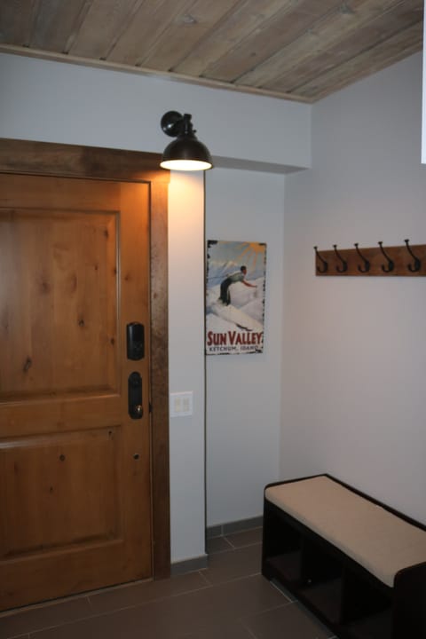 Entry bench with underneath shoe storage and coat/helmet hooks