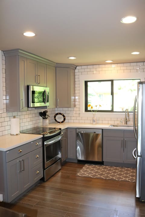 All new: subway tiles, gray cabinets, white quartz counter tops, hardwood floors