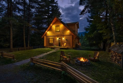 Wilmington Range Chalet twilight with burning campfire in summer