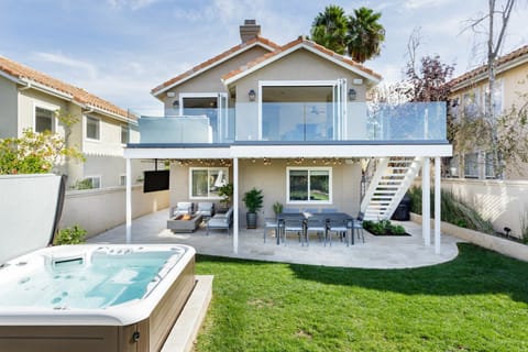 Relaxing back yard with private hot tub, TV, fire pit, and RH furniture!
