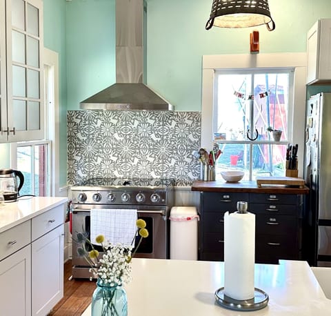 Kitchen is fully stocked with dishes, cooking supplies, spices, etc. 