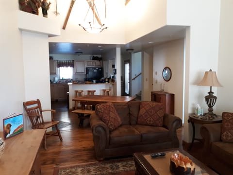 View from vaulted Living room towards Kitchen. New Hardwood Flooring