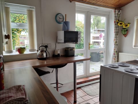 French doors open out onto patio, garden and decking area.