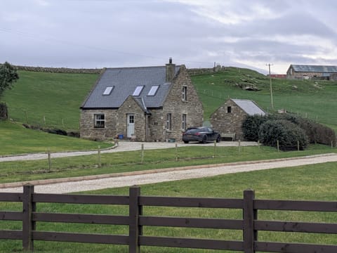 Cottage blends into the stone farmland surrounding it.