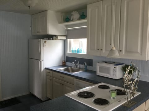 Kitchen with dishwasher, stove top, oven, microwave and refrigerator.  