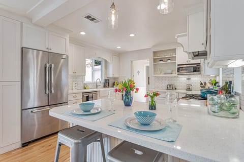 Beautifully designed open kitchen well stocked with cookware.